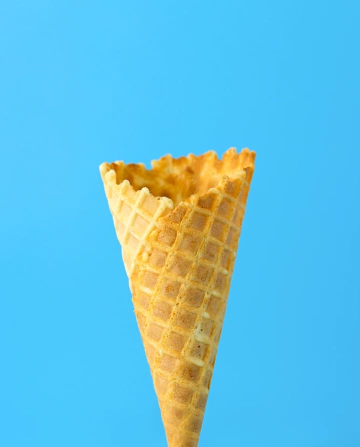 empty icecream cone on blue background